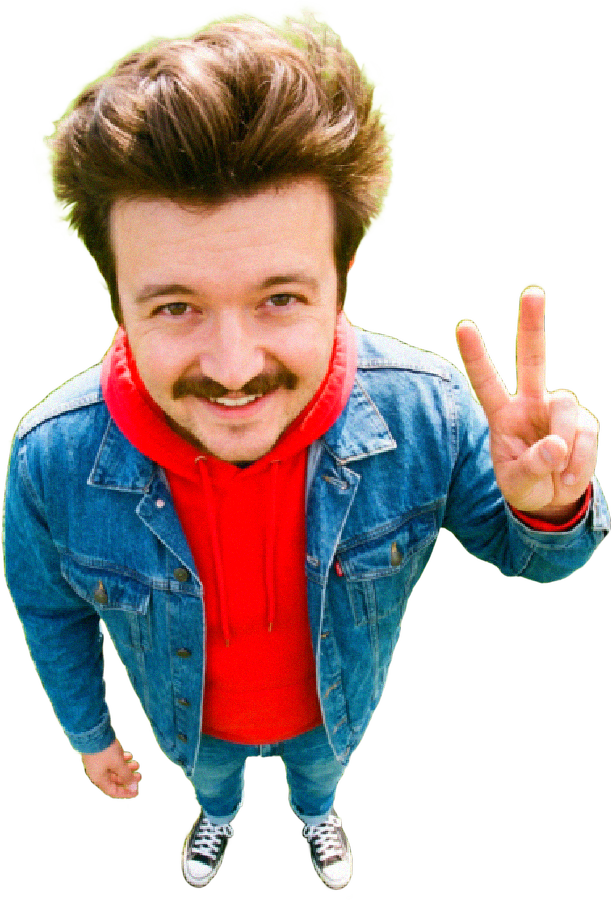 Garrison Bullock standing on a tiny grass planet, throwing a peace sign
