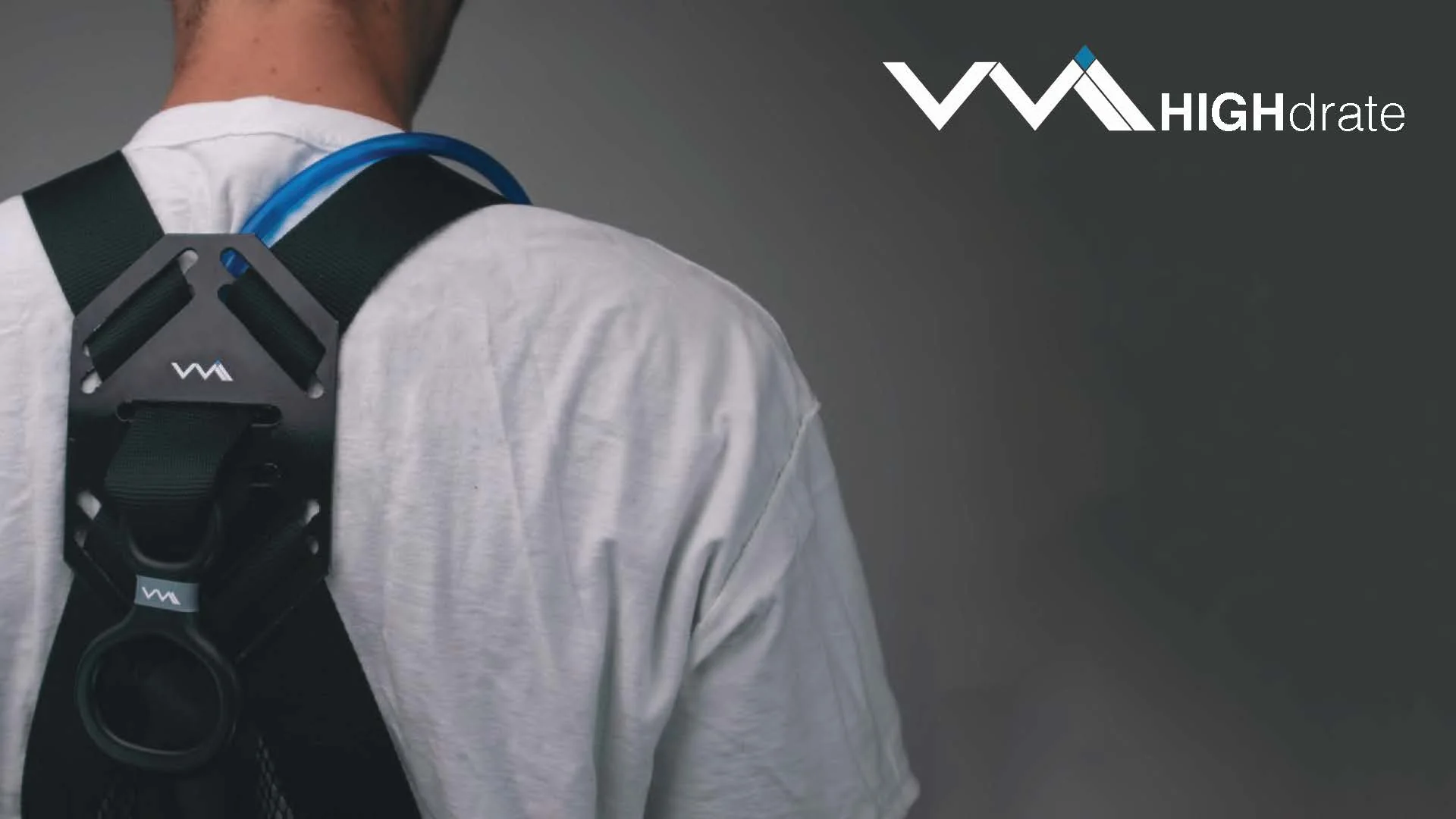 HIGHdrate harness worn over a white t-shirt, the hydration hose running over the shoulder